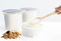 Hand`s woman holding wooden spoon with healthy flavored yogurt i
