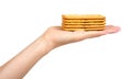 Hand with salty cracker, crispy appetizer, rectangle shape cookie. Isolated