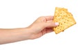 Hand with salty cracker, crispy appetizer, rectangle shape cookie. Isolated