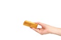 Hand with salty cracker, crispy appetizer, rectangle shape cookie. Isolated