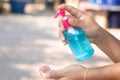 Hand sanitizer, alcohol bottle, held in hand. Disinfecting concept: liquid soap, squeezing blue gel For anti-virus and anti-