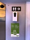 Hand sanitizer dispenser and covid safety signage in a Go Train.