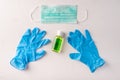Hand sanitizer gel bottle, face mask, rubber gloves on light background. Copy space Royalty Free Stock Photo