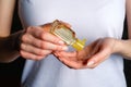 Hand sanitizer gel bottle in female hands. Woman applying antiseptic disinfect liquid. Coronavirus Disease Covid-19 prevention