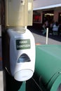 Hand sanitizer in a public place on the street near a fast food cafe.