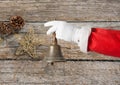 Hand of santa claus holding christmas bell