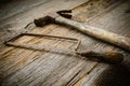 Hand Saw and Hammer on Rustic Wood