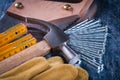 Hand saw leather gloves construction nails wooden meter and claw Royalty Free Stock Photo