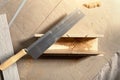 Hand saw with a shape for the correct bending angle. DIY repair at home, hand saw