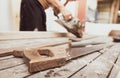 Hand saw with a wooden handle on blur carpenter working with electric wood planer. Carpenter tools. Hand saw and sawdust on wood Royalty Free Stock Photo