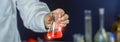 Hand scientist holding flask lab glassware in chemical laboratory, science laboratory research and development concept