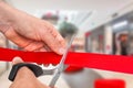 Hand with scissors cutting red ribbon - opening ceremony Royalty Free Stock Photo