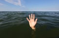 hand on the sea of a person who is drowning and seeks help