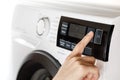 The hand select settings for laundry on modern digital display. Close-up view of automatic washing machine with touch screen on Royalty Free Stock Photo