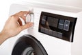 The hand select settings for laundry on modern digital display. Close-up view of automatic washing machine with touch screen on Royalty Free Stock Photo