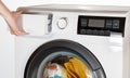 The hand select settings for laundry on modern digital display. Close-up view of automatic washing machine with touch screen on Royalty Free Stock Photo