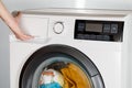 The hand select settings for laundry on modern digital display. Close-up view of automatic washing machine with touch screen on Royalty Free Stock Photo