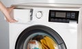 The hand select settings for laundry on modern digital display. Close-up view of automatic washing machine with touch screen on Royalty Free Stock Photo