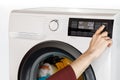 The hand select settings for laundry on modern digital display. Close-up view of automatic washing machine with touch screen on Royalty Free Stock Photo