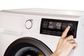 The hand select settings for laundry on modern digital display. Close-up view of automatic washing machine with touch screen on