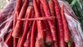 hand selecting fresh red carrots at vegetable market Royalty Free Stock Photo