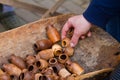 Hand selects a baby toy pot from a pile of small handmade ceramic clay jugs, bowls and pots, Ukrainian traditional art souven Royalty Free Stock Photo