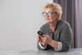 Hand of senior woman with an attached pulse oximeter on fingertip,old elderly measuring heart rate, checking oxygen