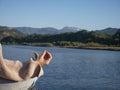 Hand senior woman yoga and lotus pose meditation and relax in the mountan lake. Healthy and Zen Concept Close up