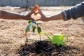 The hand of the senior woman and the hand of young women are make heart sign after helping each other to plant trees, World Royalty Free Stock Photo