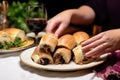 hand serving coq au vin bread rolls on a side plate Royalty Free Stock Photo