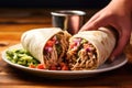 hand serving a pulled pork burrito plate