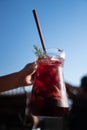 Hand serving Sangria with red wine in a jug Royalty Free Stock Photo