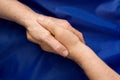 Hand shake against a blue background Royalty Free Stock Photo