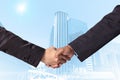 Hand shake between a businessman on Modern business building glass area background Royalty Free Stock Photo