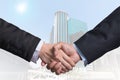 Hand shake between a businessman on Modern business building Royalty Free Stock Photo