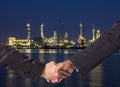 Hand shake between a businessman on Petrochemical factory background