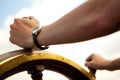 Hand on ship rudder. Royalty Free Stock Photo