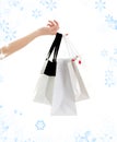 Hand with shopping bags and snowflakes Royalty Free Stock Photo