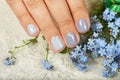 Hand with short manicured nails colored with gray nail polish Royalty Free Stock Photo