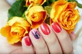 Hand with short manicured nails colored with pink and red nail polish Royalty Free Stock Photo