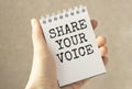 Hand show Share Your Voice text written on small Royalty Free Stock Photo