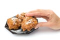 Hand showing dutch oliebol or fritter