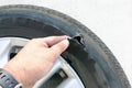 Hand showing flat ruptured damaged tire wheel with rim Royalty Free Stock Photo