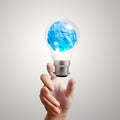 Hand showing light bulb crumpled paper Royalty Free Stock Photo