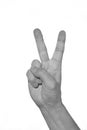 Hand showing peacy victory sign against pure. black and white