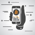 Hand showing phone with bitcoin graph going down