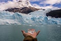 Hand showing a piece of ice from rthe spegazzini glacier in Argentina