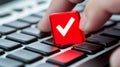 Hand Pressing Red Checkmark Confirmation Button on Laptop Keyboard with Security Alert Concept Royalty Free Stock Photo