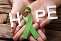 Hand Showing Ribbon With Hope Text