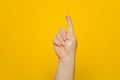 Hand shows index finger isolated on orange background, with clipping path, concept press the button first, double click Royalty Free Stock Photo